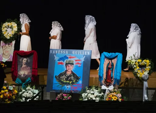 Ladies from the Queen of Peace Church walk to the stage to pray the rosary during the memorial service of U.S. Army Specialist Vanessa Guillén at the Cesar Chavez High School on Aug. 14, 2020, in Houston. A federal judge has sentenced a Texas woman Monday, Aug. 14, 2023, to 30 years in prison for helping to dispose of the body of U.S. soldier Guillén. The 2020 killing led to changes in how women in the military can report sexual abuse. (Marie D. De Jesus/Houston Chronicle via AP, Pool, File)