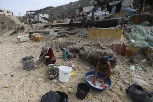 Palestinians resort to the sea water to bathe and clean their tools and clothes due the continuing water shortage in the Gaza Strip, on the beach of Deir al-Balah, Central Gaza Strip, Sunday, Oct. 29, 2023. With the Israel-Hamas war in its second month and more than 10,000 people killed in Gaza, trapped civilians are struggling to survive without electricity or running water. Each day has become a mind-numbing cycle of searching for bread and water and waiting in lines. A sense of desperation ha