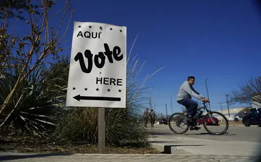 Voters leave an early voting poll site, Feb. 14, 2022, in San Antonio. (AP Photo/Eric Gay, File)