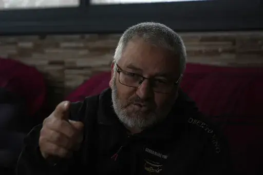 Mohammed Shula speaks at a relative's house, where he and his wife have taken refuge, in the West Bank village of Kafr al-Labad, Monday, Feb. 10, 2025. (AP Photo/Nasser Nasser)