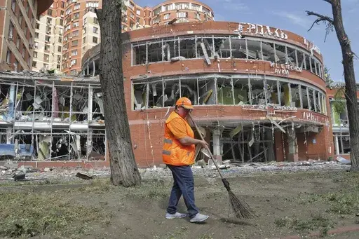 Municipal workers clean at the scene of a nightly Russian rocket attack in Odesa, Ukraine, Wednesday, June 14, 2023. Officials say Russian forces have fired cruise missiles at the southern Ukrainian city of Odesa overnight and shelling has destroyed homes in the eastern Donetsk region, killing at least six people and injuring more than a dozen others.(AP Photo/Nina Lyashonok)
