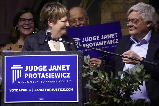 Judge Janet Protasiewicz and her husband Randy Nass share a moment during her election night party as she advances as a candidate in the April 4 election for Wisconsin Supreme Court Tuesday, Feb. 21, 2023, at Cooperage in Milwaukee. (Ebony Cox/Milwaukee Journal-Sentinel via AP)