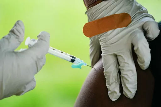 A health worker administers a dose of COVID-19 vaccine during a vaccination clinic in Reading, Pa. On Friday, Nov. 24, 2023, The Associated Press reported on stories circulating online incorrectly claiming Pfizer’s COVID-19 vaccine contains a DNA sequence called Simian Virus 40 that can cause health problems, including cancer. (AP Photo/Matt Rourke, File)