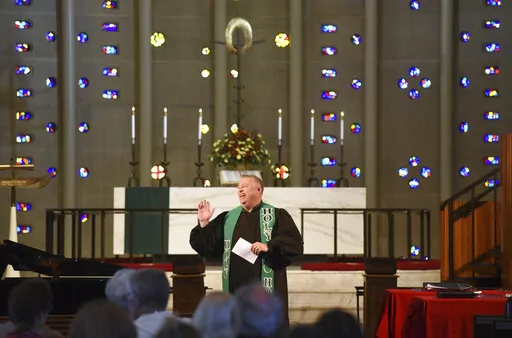 Rev. Chris Morgan leads his congregation at Christ United Methodist Church in Bethel Park Sunday, Oct. 9, 2022. The church has a diverse congregation with most leaning toward the center. In regional gatherings across the country this year, United Methodists approved requests of about 300 congregations to quit the denomination primarily over debates over sexuality and theology. (AP Photo/Philip G. Pavely)