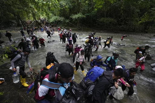 Migrants cross a river during their journey through the Darien Gap from Colombia into Panama, hoping to reach the U.S., Oct. 15, 2022. President-elect José Raúl Mulino said Thursday, May 9, 2024, he will shut down the migration route used by more than 500,000 people last year. Until now, Panama has helped speedily bus the migrants across its territory so they can continue their journey north. (AP Photo/Fernando Vergara, File)