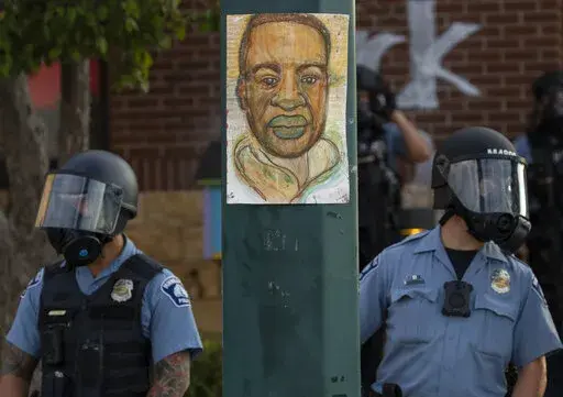 Minneapolis police stand outside the department's 3rd Precinct on May 27, 2020, in Minneapolis. Almost two years after George Floyd died at the hands of four Minneapolis police officers, Minnesota's Department of Human Rights was set Wednesday, April 27, 2022, to announce findings from its investigation into whether the city police department had a pattern or practice of racial discrimination in policing. (Carlos Gonzalez/Star Tribune via AP)