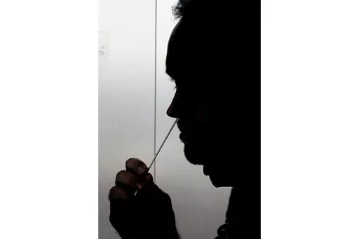 FILE - A rapid COVID-19 test is taken, Wednesday, Nov. 18, 2020, in Salt Lake City. President Joe Biden says the federal government will buy half a billion COVID-19 rapid test kits and distribute them free of charge to people to use at home. Delivery of the first batch of the 500 million tests isn't expected until early January 2022. (AP Photo/Rick Bowmer, File)