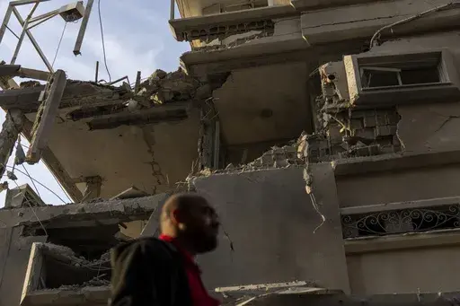 A man looks at damaged building after projectiles fired from Lebanon hit a home in Tira, central Israel, Saturday, Nov. 2, 2024. (AP Photo/Ariel Schalit)