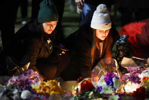 Mourners attend a vigil at The Rock on the grounds of Michigan State University in East Lansing, Mich., Wednesday, Feb. 15, 2023. Alexandria Verner, Brian Fraser and Arielle Anderson were killed and several other students remain in critical condition after a gunman opened fire on the campus of Michigan State University Monday night. (AP Photo/Al Goldis)