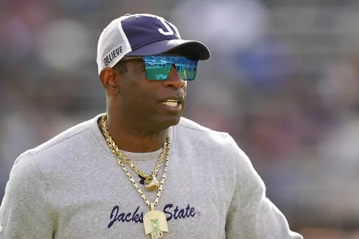 Jackson State head coach Deion Sanders surveys his players during warmups prior to the Southwestern Athletic Conference championship NCAA college football game against Southern University, Saturday, Dec. 3, 2022, in Jackson, Miss. Jackson State won 43-24. (AP Photo/Rogelio V. Solis)
