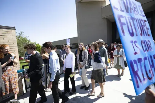 Youth plaintiffs in the Held v. Montana climate case leave the Montana Supreme Court, Wednesday, July 10, 2o24, in Helena, Mont., after oral arguments before the state's highest court. Attorneys for Republican officials pressed Montana's Supreme Court on Wednesday to overturn a landmark climate ruling that said the state was violating residents' constitutional right to a clean environment by allowing oil, gas and coal projects without regard for global warming. (Thom Bridge/Independent Record vi
