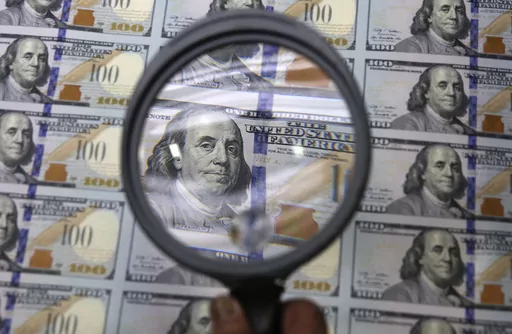 A sheet of uncut $100 bills is inspected during the printing process at the Bureau of Engraving and Printing Western Currency Facility in Fort Worth, Texas, on Sept. 24, 2013. An Associated Press analysis published on Monday, June 12, 2023, found that fraudsters potentially stole more than $280 billion in COVID-19 relief funding; another $123 billion was wasted or misspent. Combined, the loss represents a jarring 10 percent of the total $4.2 trillion the U.S. government has so far disbursed in C