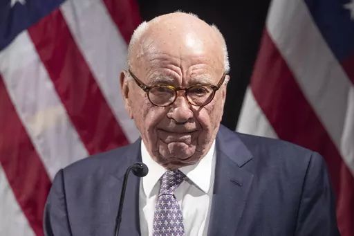 Rupert Murdoch introduces Secretary of State Mike Pompeo during the Herman Kahn Award Gala, Oct. 30, 2019, in New York. A defamation lawsuit against Fox News is revealing blunt behind-the-scenes opinions by its top figures about Donald Trump, including a Tucker Carlson text message where he said “I hate him passionately.” Carlson's private conversation was revealed in court papers at virtually the same time as the former president was hailing the Fox News host on social media for a “great 