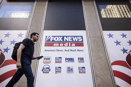 A person walks past the Fox News Headquarters in New York, Wednesday, April. 12, 2023. Dominion Voting Systems' defamation lawsuit against Fox News for airing bogus allegations of fraud in the 2020 election is set to begin trial on Tuesday, April 18, 2023, in Delaware. (AP Photo/Yuki Iwamura, File)