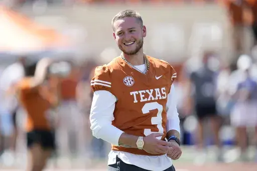 Injured Texas quarterback Quinn Ewers (3) watches warmups before an NCAA college football game against Mississippi State in Austin, Texas, Saturday, Sept. 28, 2024. (AP Photo/Eric Gay)