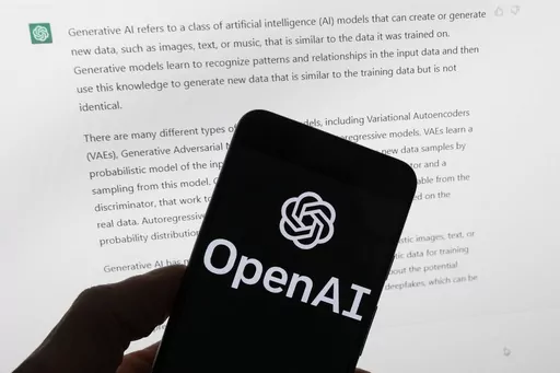 The OpenAI logo is seen on a mobile phone in front of a computer screen displaying output from ChatGPT, March 21, 2023, in Boston. Digital news outlets The Intercept, Raw Story and AlterNet are joining the fight against unauthorized use of their journalism in artificial intelligence, filing a copyright-infringement lawsuit Wednesday, Feb. 28, 2024, against ChatGPT owner OpenAI. (AP Photo/Michael Dwyer, File)